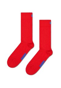 Czerwone bawełniane skarpetki o gładkiej fakturze. Posiadają niebieskie logo "HAPPY" blisko kostki oraz prążkowany mankiet na górze.