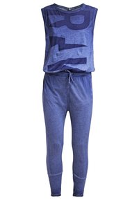 Blå tvådelad jumpsuit med en ärmlös topp med en stor grafisk design och byxor med dragsko i midjan samt åtsittande muddar. Mjuk textur.