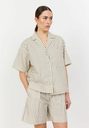 Lightweight, cream-colored pajama set featuring contrasting dark stripes, short sleeves, and button-up design with a chest pocket.