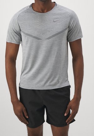 Gray athletic t-shirt with a textured pattern, short sleeves, and black accents. Paired with black shorts. Nike logo on the chest.