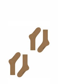 Brązowe bawełniane skarpetki pokazane w dwóch stylach: długość do kostki i długość do połowy łydki. Obie mają subtelne logo przy kostce.