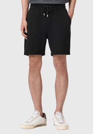 Czarne bawełniane szorty z elastycznym pasem i sznurkiem do regulacji. Posiadają boczne kieszenie i luźny krój, odpowiednie do codziennego noszenia.