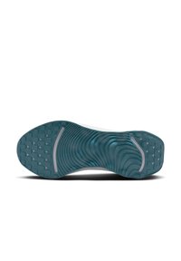 Sola de sapato com uma superfície de borracha texturizada em teal, apresentando um padrão de ondas e pequenos grips circulares para tração. Acento de entressola branca.