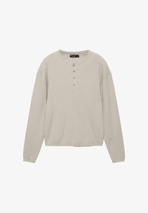 Béžový žebrovaný pletený svetr s dlouhými rukávy, kulatým výstřihem a čtyřmi knoflíky, volný střih.