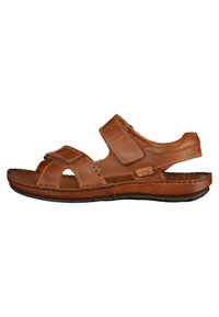 Brown leather sandal with Velcro straps, open toe design, stitched accents, textured insole, and flexible rubber sole.