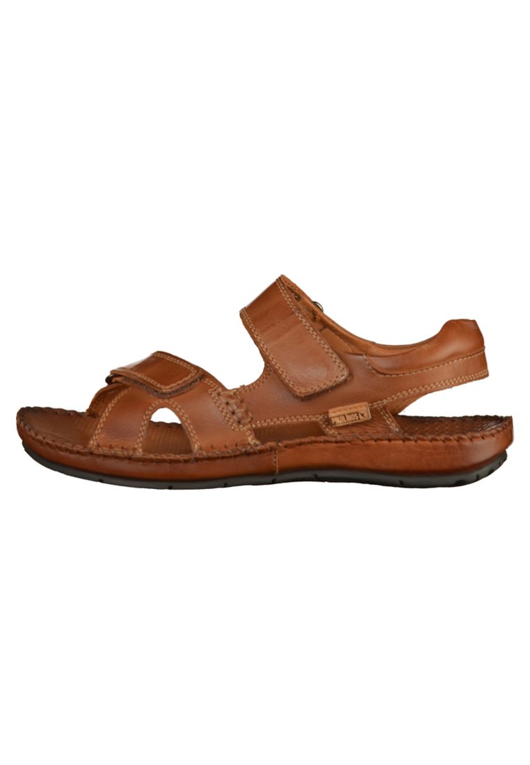 Brown leather sandal with Velcro straps, open toe design, stitched accents, textured insole, and flexible rubber sole.