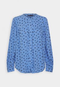 Blusa azul con mangas largas, cuello redondo y cierre de botones. Presenta un patrón floral en un azul más oscuro. Tejido suave con un corte relajado.