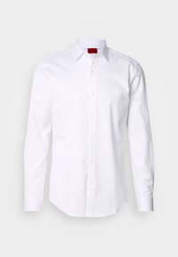 White long-sleeve shirt with herringbone texture, button-down collar, and red logo label on the inner collar. Standard fit with front buttons.