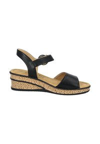 Sandalo con zeppa in pelle nera, con punta aperta e cinturino alla caviglia, dotato di una suola con texture a sughero e design curvo per il massimo comfort.