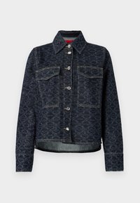 Mørkeblå denimjakke med blomstermønster, som har to brystlommer, sølvfargede trykknapper og en avkortet design med en lett slitt kant.