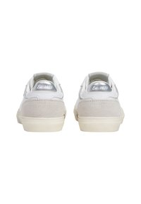 White and light grey sneakers featuring a suede heel, a smooth leather upper, and textured rubber soles with a simple design.
