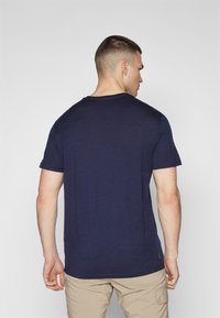 Navy short-sleeve t-shirt in a smooth, breathable fabric. Features a classic crew neck and a relaxed fit, with no visible patterns or graphics.