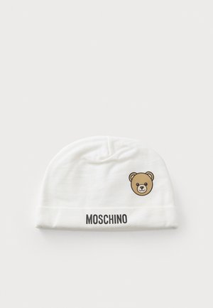 White Moschino baby hat with a folded brim, featuring a small brown teddy bear face on front and black "Moschino" text on the brim.