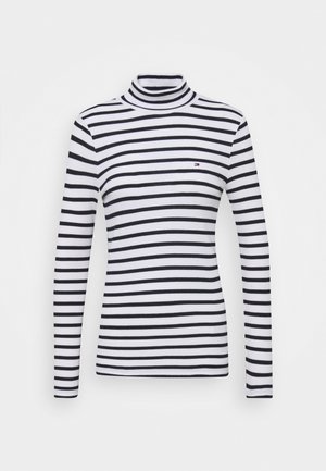 Jersey de cuello alto a rayas en blanco y negro con mangas largas, hecho de una tela suave. Presenta un pequeño logotipo en el pecho. Diseño ajustado clásico.