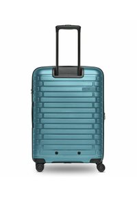 Valigia rigida di colore teal, con un design a righe, manico telescopico, quattro ruote girevoli e chiusura con zip.