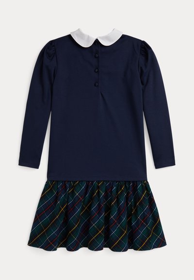 Tamsiai mėlyna ilga suknelė su balta apykakle, mygtukų užsegimas gale ir languota sijonė su volanais žalia, raudona, geltona ir balta spalvomis.