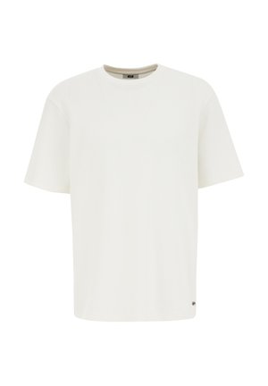 Valge lühikeste varrukatega T-särk, mis on valmistatud tekstuursest materjalist. Omab ümmargust kaelust ja väikest logoaktsenti allääres. Klassikaline mudel.