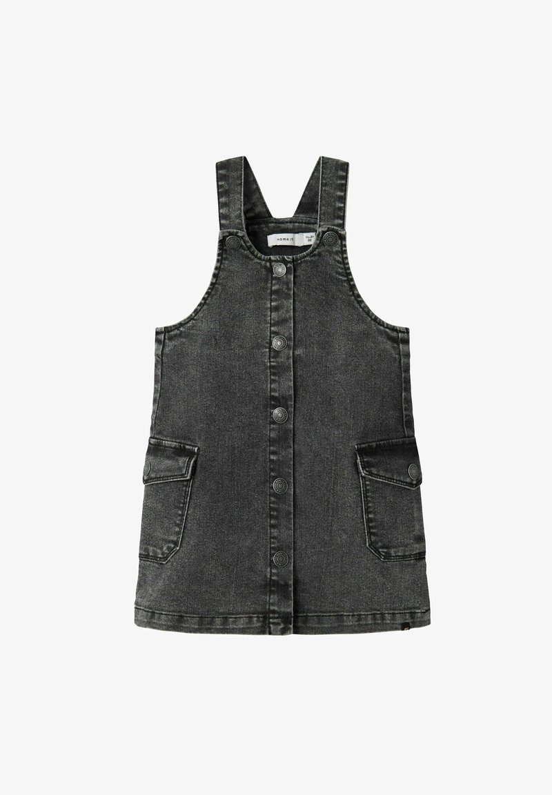 Robe salopette enfant en denim noir sans manches avec boutons-pression à l'avant et deux poches à rabat boutonnées.