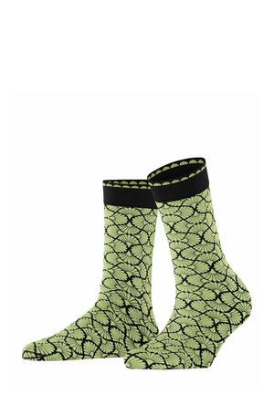 Green patterned socks featuring a leaf design on a black background, with a ribbed black cuff and a smooth texture.