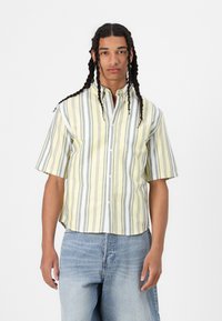 Camicia a maniche corte con bottoni, a righe verticali gialle e grigie, realizzata in tessuto leggero, con colletto e chiusura frontale con bottoni.