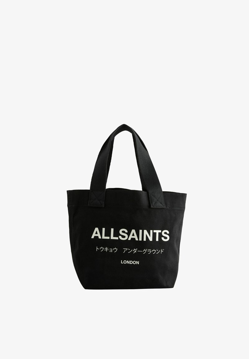 Sac fourre-tout en toile noire avec double poignée. Le devant présente un texte imprimé en blanc : "ALLSAINTS", des caractères japonais, et "LONDON" en bas.