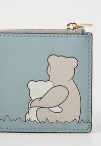 Light blue vegan leather wallet featuring two cartoon bears hugging, with a plain design and contrasting outlines. Gold zipper hardware.