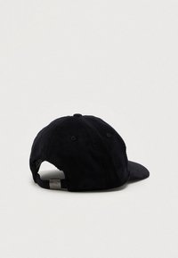 Gorra de béisbol de pana negra con visera curva, correa ajustable en la parte posterior y tela texturizada. Sin logotipos ni adornos visibles.