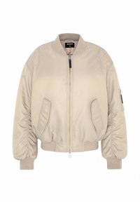 Beige bomberjakke med lynlås, ribbede manchetter og kant, samt to sidelommer. Glat stof med en let polstret tekstur.