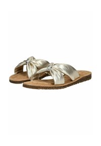 Sandales à glissière en métal doré avec des brides nouées, semelle intérieure en daim douce et semelle texturée marron. Design minimaliste pour une tenue décontractée.