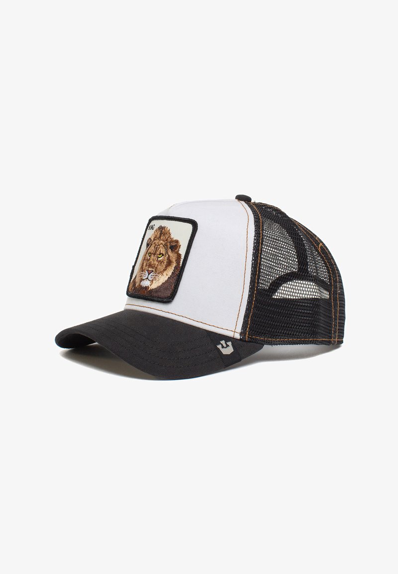 Gorra snapback de malla en blanco y negro con un parche bordado de un león en la parte frontal, con visera curva y acentos de costura marrón.