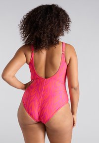 Enbiten baddräkt i klar rosa med ett bladmönster, med öppen rygg, justerbara axelband och smidig, elastisk tyg.