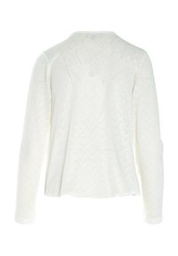 Pull à manches longues texturé blanc avec un motif ondulé et une coupe décontractée. Doté d'un col rond et d'une finition mi-longue.