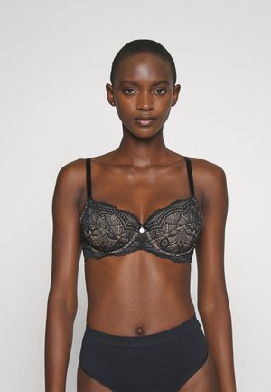 Svart blonde BH med intrikate blomsterdesign, semi-transparente kopper, justerbare stropper og en dekorativ midtperle.
