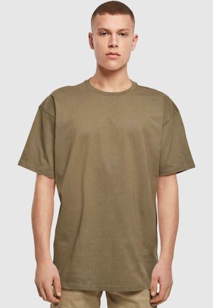 Olivově zelené oversized tričko s kulatým výstřihem a krátkými rukávy. Vyrobeno z jemně žebrované látky, nabízí uvolněný střih a minimální švy.