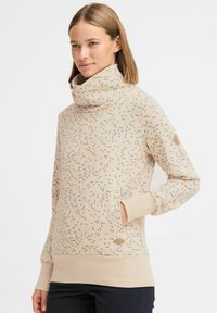 Felpa beige con colletto alto, tessuto testurizzato e motivi multicolore sparsi. Presenta tasche laterali e polsini a coste.