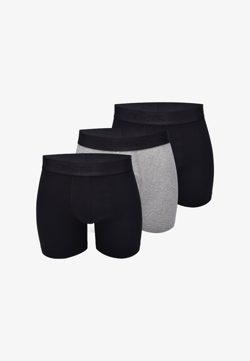 Men's briefs in a pack of three; two black and one gray. Fabric is smooth with elasticized waistband displaying the brand name.