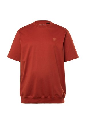 T-shirt a maniche corte, col tondo in cotone arancione bruciato. Presenta un logo sottile di colore marrone chiaro nella zona sinistra del petto. Texture liscia.