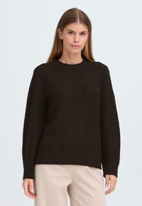 Black textured knit sweater with long sleeves and ribbed hem. The round neckline complements the loose design, suitable for casual wear.