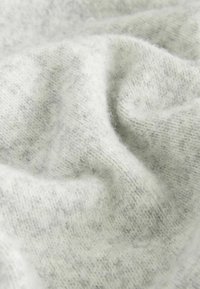 Light gray knitted fabric with a soft texture, featuring subtle variations in color and a slightly fuzzy appearance.