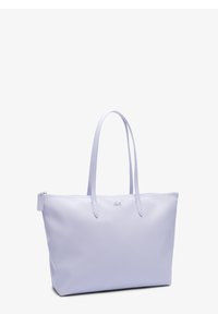 Bolso tote color lila claro hecho de cuero liso con dos asas, cierre de cremallera y detalle sutil de logo en el frente.