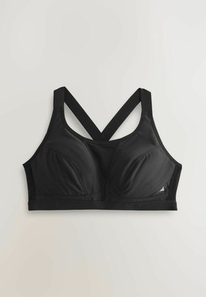 Must spordirinnahoidja vormitud tasside, laiade ristpitsade ja sileda kangaga. Omaduseks on pehme logo ja allosas elastne riba.