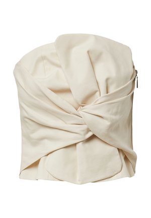 Cream-colored strapless top made of smooth fabric, featuring twisted detailing at the front and a zipper closure at the side.