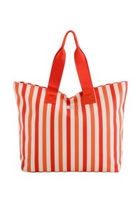 Červenobílá pruhovaná taška přes rameno se dvěma pevným červenými uchy, s širokým otvorem a pevnou strukturou. Vyrobeno z odolného materiálu.
