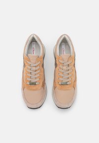 Beige and brown suede and leather sneakers with a padded collar, beige laces, a silver logo accent, and a white sole. Size 37.