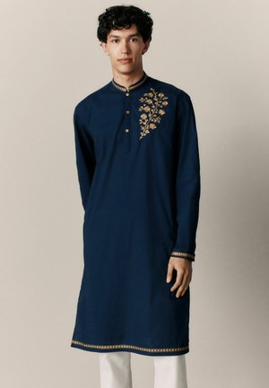 Navy blue kurta made of soft fabric, featuring golden floral embroidery on the left chest and detailed trim at the collar and hem.
