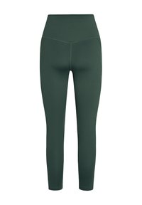 Tumerohelised kõrge vöökohaga retuusid V-kujulise õmblusega vöökohal, jalas tihedalt istuvad, valge tausta ees.