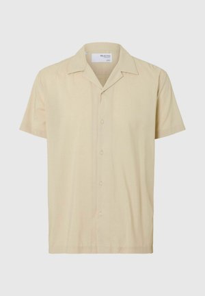 Kortärmad skjorta med knappar i ljusbeige tyg. Har en klassisk krage, fem knappar och en avslappnad passform. Slät textur, minimal mönstring.