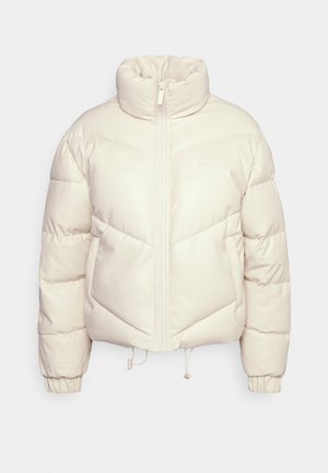 Jachetă puffer scurtă de culoare crem, cu guler înalt, fermoar frontal și manșete elastice. Prezintă cusături în formă de zigzag și un accent cu logo.