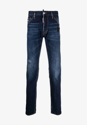 Dark blue denim jeans with a straight leg cut, featuring subtle whiskering, a button closure, and a small branded patch on the rear.
