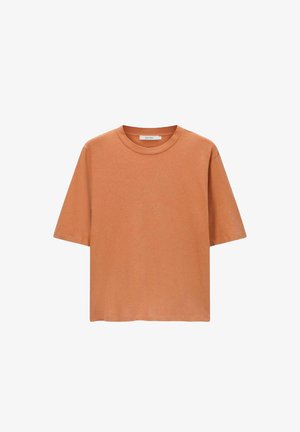 Korte mouwen t-shirt in roestoranje, gemaakt van zacht katoen, met een ronde hals en een ontspannen pasvorm, zonder zichtbare logo's.